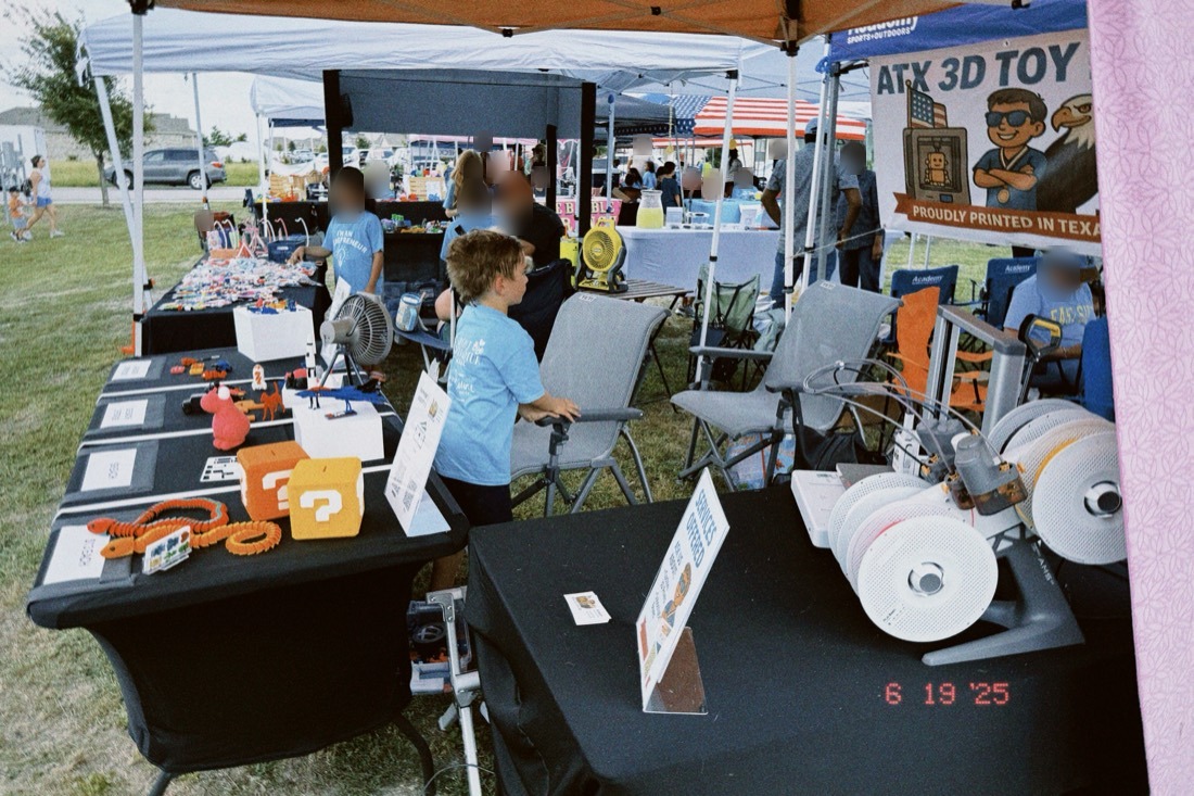 Our 3D printers running on a table at an Austin market